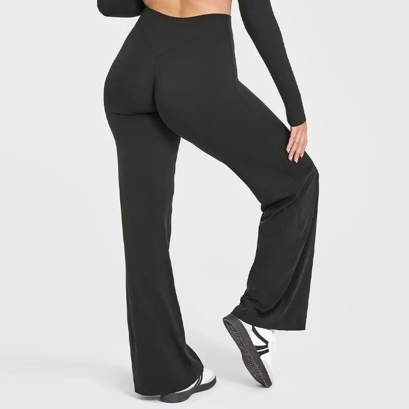Person wearing black wide-leg pants on a white background