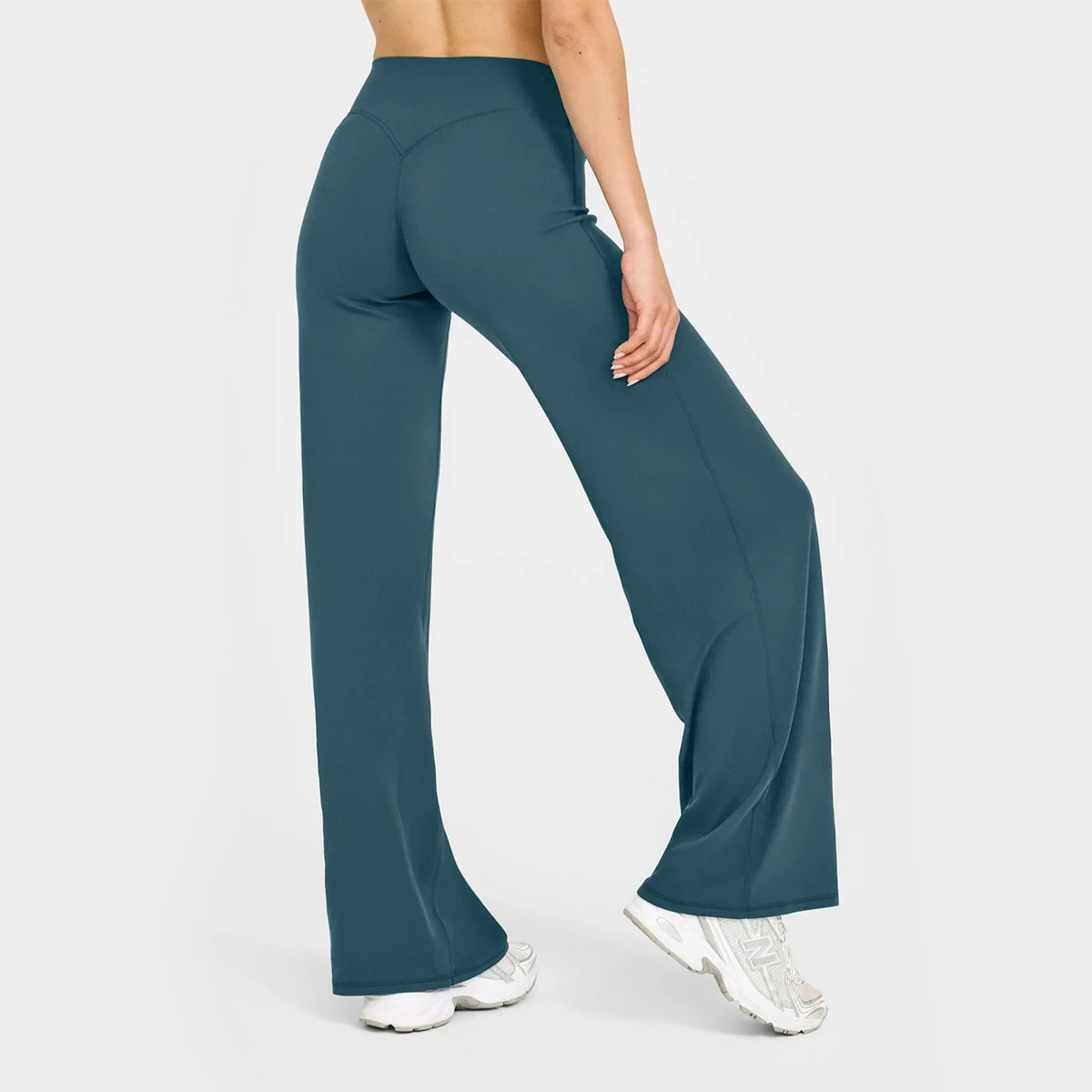 Teal yoga pants worn by a person on a white background